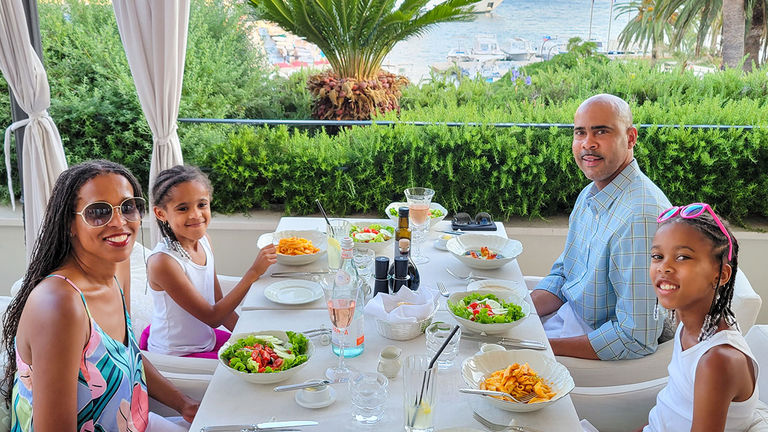 The author (far left) and her family having dinner in Hvar.